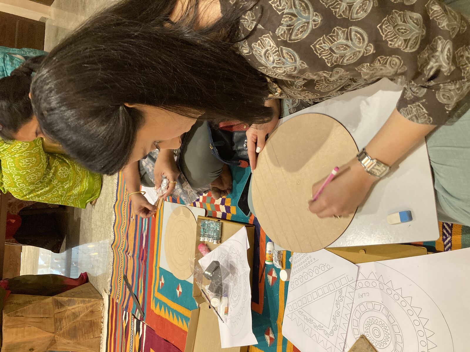 Guests with their finished mosaic artworks