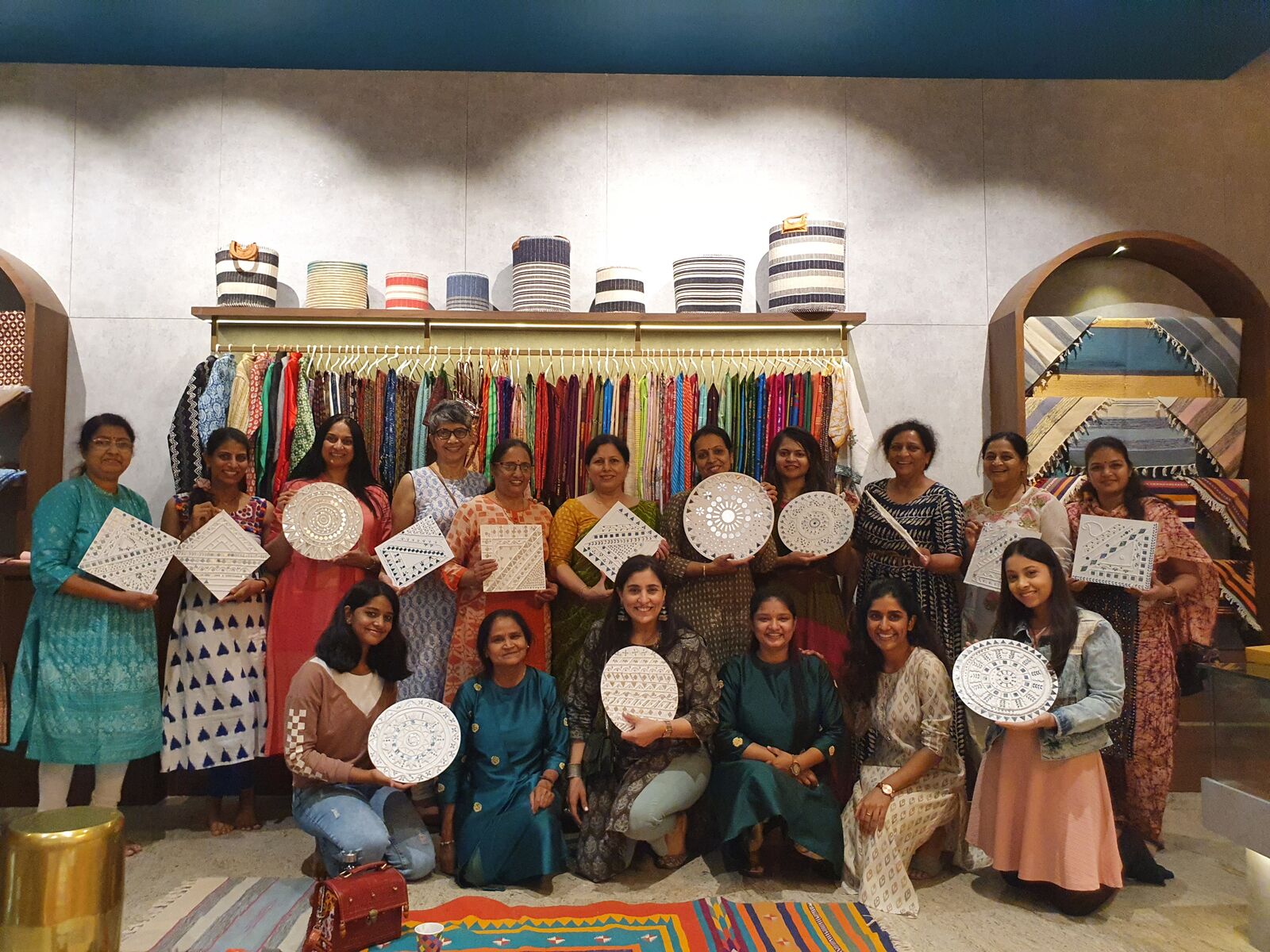 Guests around the workshop table setting mirror mosaic pieces